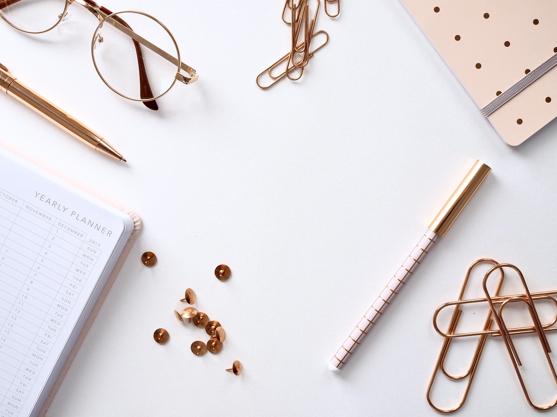Eco-friendly school supplies including a recycled notebook and wooden pencils.